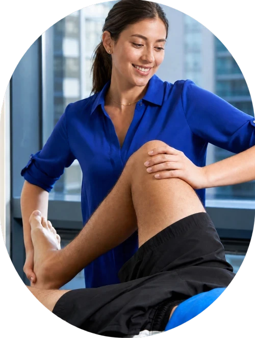 Physiotherapist providing hands-on lower-limb treatment with a patient